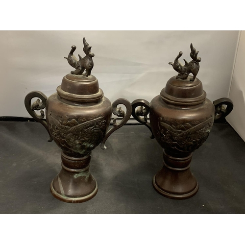 75 - A PAIR OF EARLY BRONZE LIDDED JARS HEIGHT: 26CM