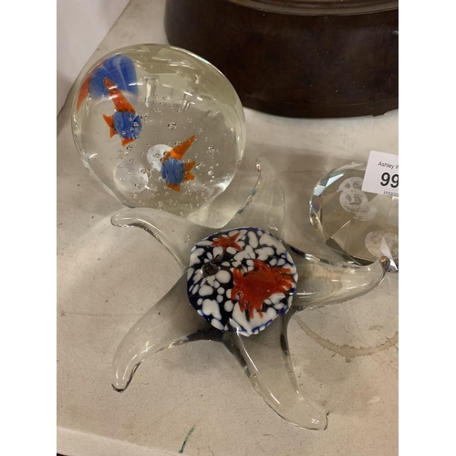 205 - THREE GLASS PAPERWEIGHTS, ONE IN THE SHAPE OF A STAR FISH