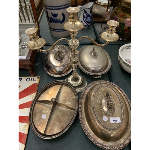 107 - A SELECTION OF SILVER PLATE SERVING DISHES TO INCLUDE A SILVER PLATE CANDLE STICK