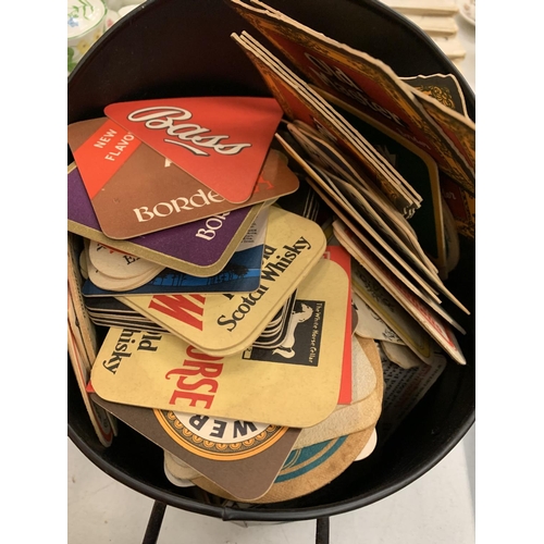 125 - A COAL SCUTTLE CONTAINING A QUANTITY OF VINTAGE BEER MATS