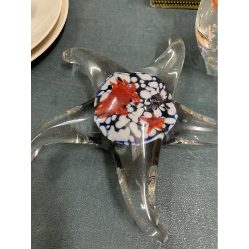 205 - THREE GLASS PAPERWEIGHTS, ONE IN THE SHAPE OF A STAR FISH