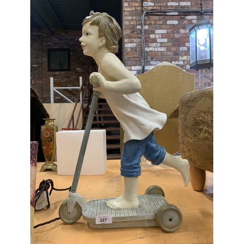 227 - A RESIN RETRO STYLE BOY ON A SCOOTER (H:54CM)