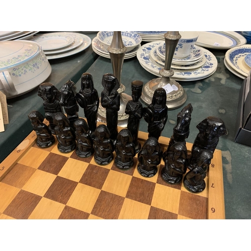 234 - A WOODEN EGYPTIAN THEME CHESS SET