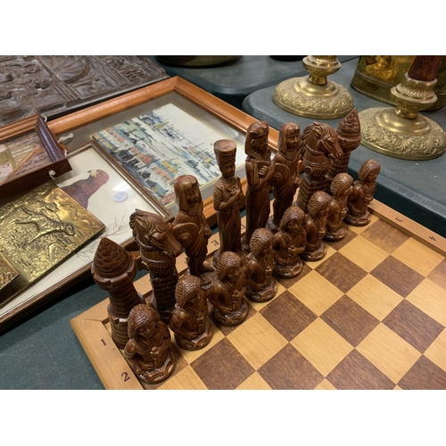 234 - A WOODEN EGYPTIAN THEME CHESS SET