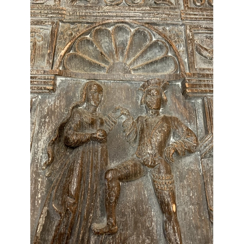 236 - A WOODEN CARVED PANEL DEPICTING A COUPLE