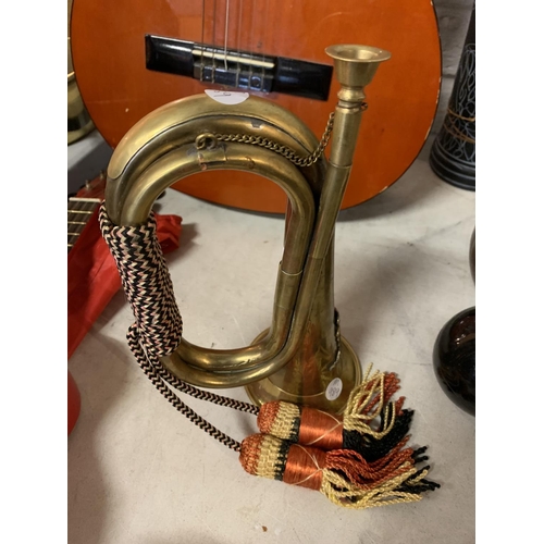 267 - A VINTAGE BRASS MILITARY BUGLE WITH BRAIDED CORD AND TASSELS