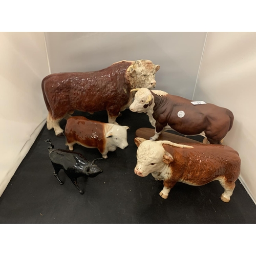 29 - FOUR HEREFORD BULL ORNAMENTS TO INCLUDE A FURTHER SMALL BLACK BULL