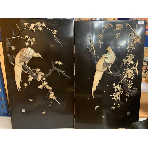 37 - A PAIR OF CHINESE EBONISED WALL PLAQUES DEPICTING MOTHER OF PEARL BIRDS WITH ARTIST'S SIGNED STAMP