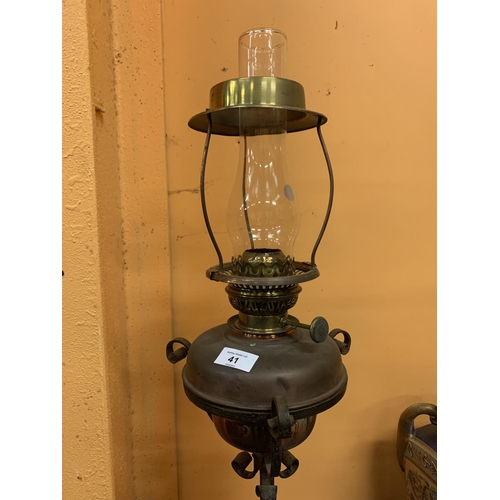 41 - A VINTAGE OIL LAMP ON AN ADJUSTABLE METAL STAND