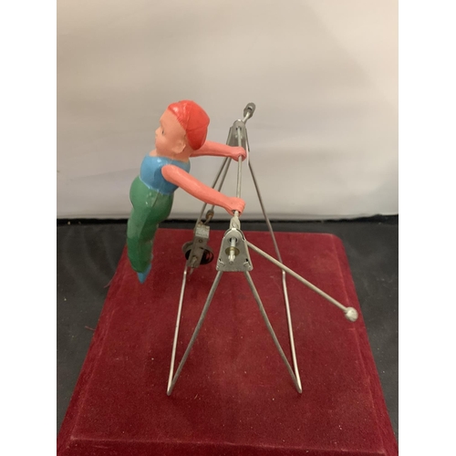 63 - A 1950s GYRATING TOY IN THE FORM OF A GYMNAST