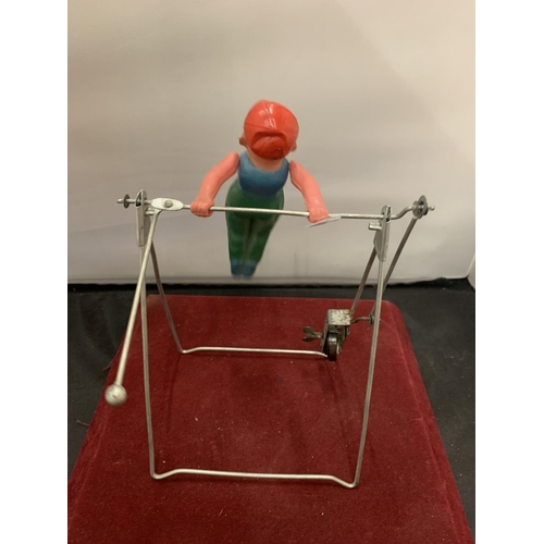 63 - A 1950s GYRATING TOY IN THE FORM OF A GYMNAST