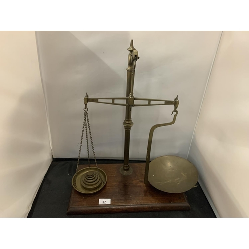 67 - A PAIR OF ANTIQUE BRASS AVERY SCALES TO INCLUDE SIX WEIGHTS