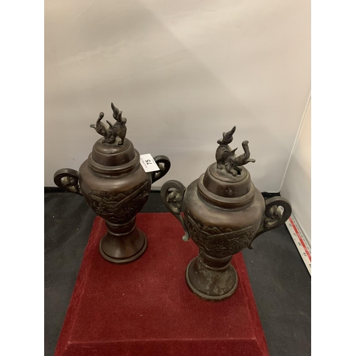 75 - A PAIR OF EARLY BRONZE LIDDED JARS HEIGHT: 26CM