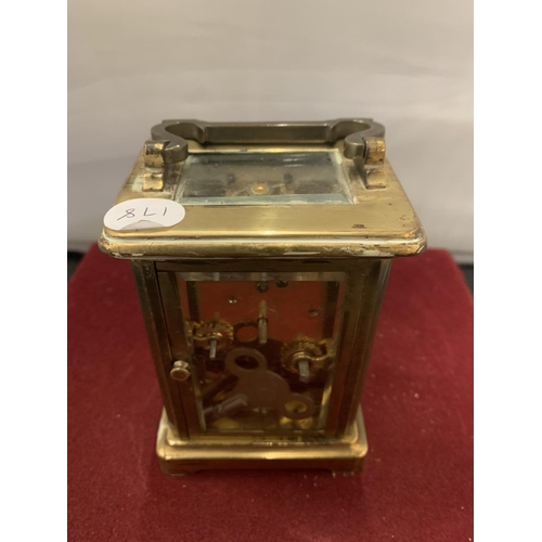 9 - A FRENCH BRASS CARRIAGE CLOCK WITH WHITE ENAMEL DIAL AND SECONDHAND FEATURE (KEY) - 11CM HIGH