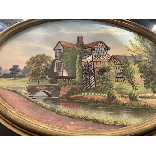 719 - A FRAMED OVAL CERAMIC PLAQUE OF LITTLE MORETON HALL BY JOHN THORLEY