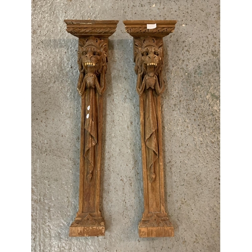 142A - A PAIR OF WOODEN LION HEAD POSTS