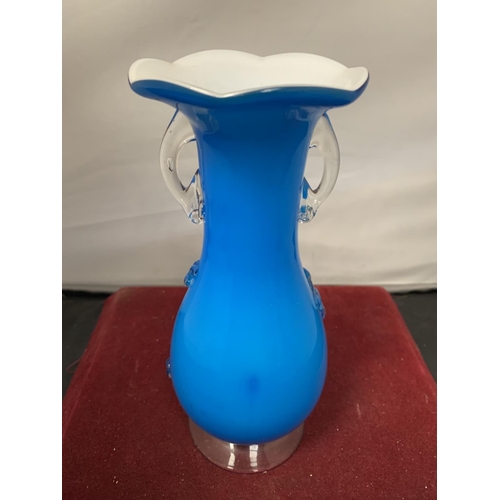 734 - A SMALL COLOURED GLASS VASE WITH TWIN HANDLES AND FLORAL RELIEF DESIGN H:20CM