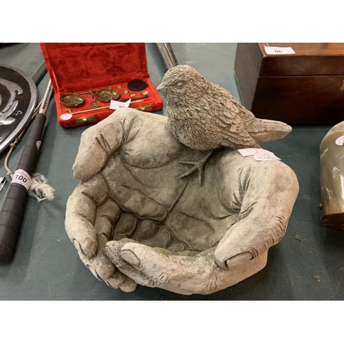 99A - A SMALL BIRD BATH IN THE FORM OF CUPPED HANDS AND A BIRD 22CM X 25CM