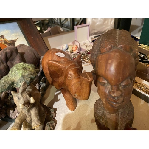 865 - AN ASSORTMENT OF TRIBAL ITEMS TO INCLUDE ELEPHANT ORNAMENTS, A TREEN TRIBAL BUST AND A FRAMED TRIBAL... 