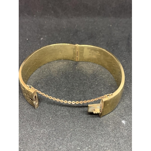 550 - A 9 CARAT GOLD BANGLE MARKED WAX FILLED GROSS WEIGHT 39.4 GRAMS