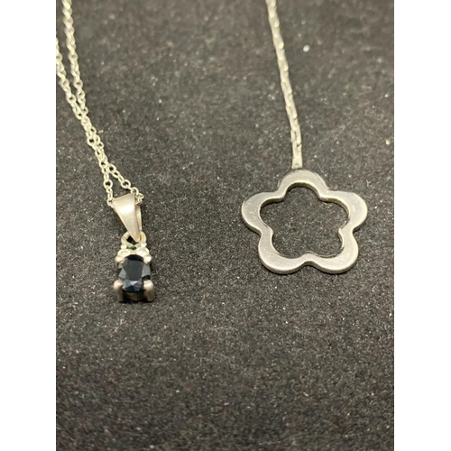 586 - THREE SILVER NECKLACES WITH PENDANTS TO INCLUDE A SIXPENCE, FLOWER AND BLACK STONE