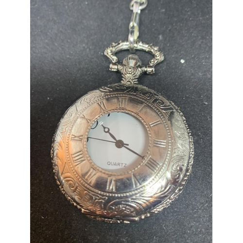 604 - AN ORNATE WHITE METAL POCKET WATCH AND CHAIN