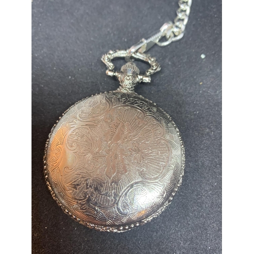 604 - AN ORNATE WHITE METAL POCKET WATCH AND CHAIN