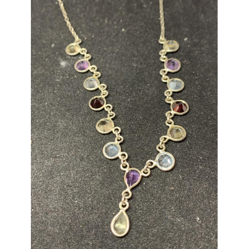 636 - THREE SILVER NECKLACES WITH PENDANTS TO INCLUDE A SWIRL WITH CLEARSTONE, A C AND VARIOUS COLOURED ST... 