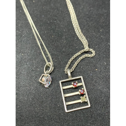 647 - FOUR SILVER NECKLACES WITH PENDANTS TO INCLUDE A CLEARSTONE, BECCA AND A RED STONE