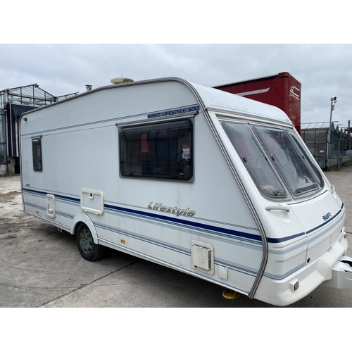 235 - A SWIFT 5 BERTH CARAVAN WITH REFRIGERATOR, COOKER, BLOW HEATER, SHOWER ETC.  - NO VAT