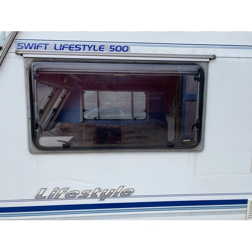 235 - A SWIFT 5 BERTH CARAVAN WITH REFRIGERATOR, COOKER, BLOW HEATER, SHOWER ETC.  - NO VAT