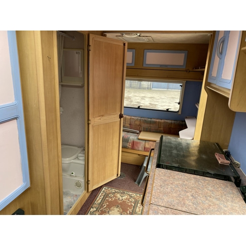 235 - A SWIFT 5 BERTH CARAVAN WITH REFRIGERATOR, COOKER, BLOW HEATER, SHOWER ETC.  - NO VAT