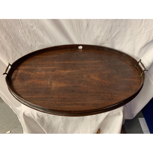 52 - A LARGE WOODEN OVAL BUTLERS TRAY AND A DECORATIVE TIN TRAY WITH VEGETABLE BOWL DESIGN