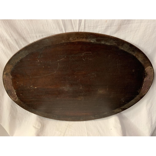 52 - A LARGE WOODEN OVAL BUTLERS TRAY AND A DECORATIVE TIN TRAY WITH VEGETABLE BOWL DESIGN