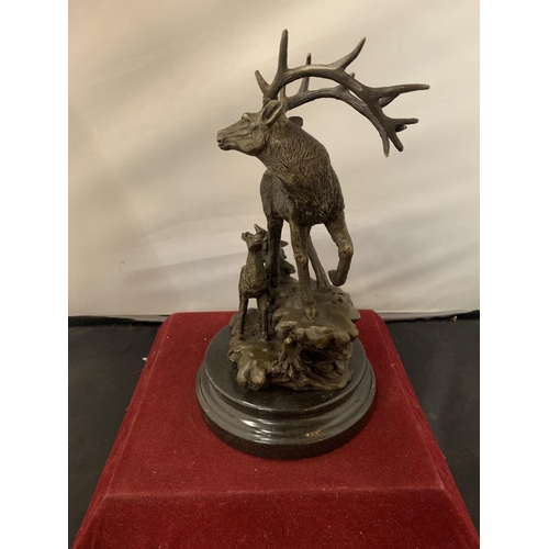 6 - A BRONZE IN THE FORM OF A STAG AND FAWN MOUNTED ON A WOODEN BASE H:APPROXIMATELY 28CM