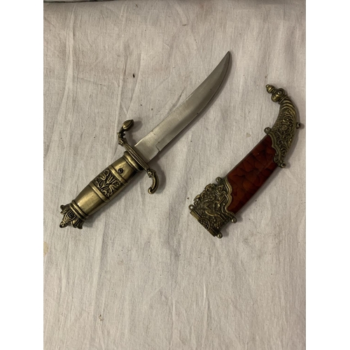 81 - AN ORNATE SHEATHED MIDDLE EASTERN DAGGER