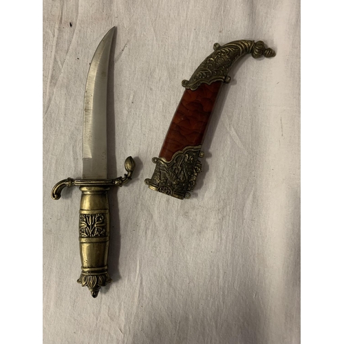 81 - AN ORNATE SHEATHED MIDDLE EASTERN DAGGER