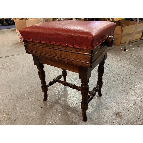 180 - A VICTORIAN OAK ADJUSTABLE PIANO STOOL WITH RED LEATHER SEAT