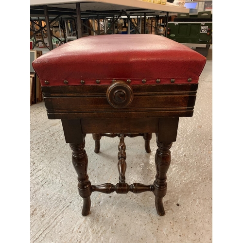 180 - A VICTORIAN OAK ADJUSTABLE PIANO STOOL WITH RED LEATHER SEAT