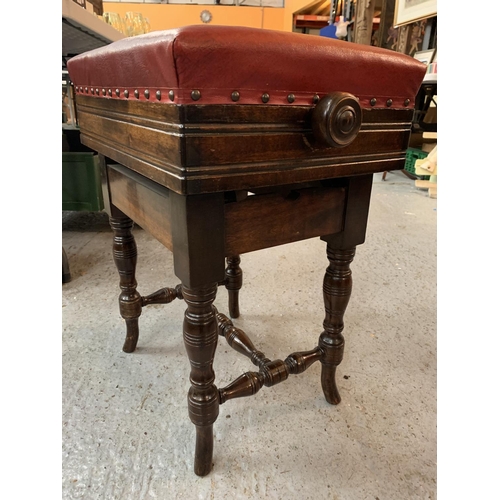 180 - A VICTORIAN OAK ADJUSTABLE PIANO STOOL WITH RED LEATHER SEAT