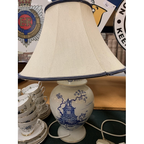 216 - A PAIR OF CERAMIC BASED BLUE AND WHITE TABLE LAMPS COMPLETE WITH SHADES H: TO BOTTOM OF BULB 37CM AP... 