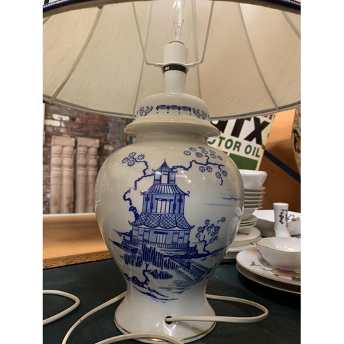 216 - A PAIR OF CERAMIC BASED BLUE AND WHITE TABLE LAMPS COMPLETE WITH SHADES H: TO BOTTOM OF BULB 37CM AP... 