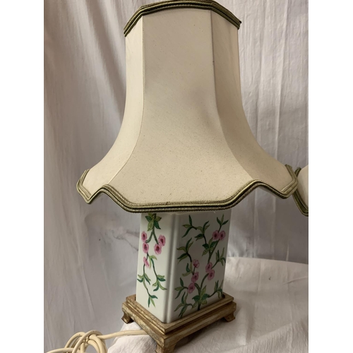 253 - A PAIR OF CERAMIC FLORAL DECORATED TABLE LAMPS ON  WOODEN BASES