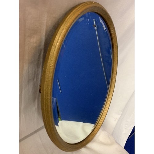 271 - A GILT FRAMED OVAL MIRROR (44 X 34 CMS)