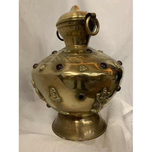 50 - A LARGE BRASS TWIN HANDLED AND LIDDED URN WITH RED STONE DECORATIVE DETAIL H:APPROX. 35CM