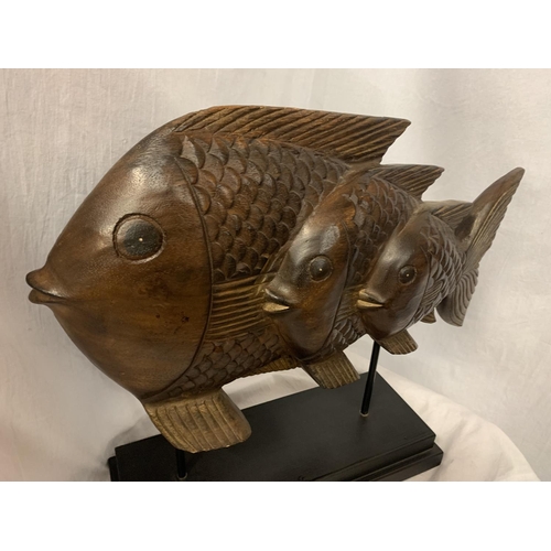 56 - A VERY LARGE HARD WOOD FISH MOUNTED ON A PLINTH OF THE SAME H: APPROX. 45CM