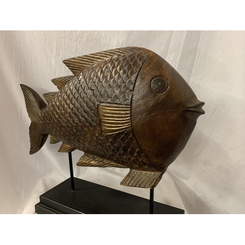 56 - A VERY LARGE HARD WOOD FISH MOUNTED ON A PLINTH OF THE SAME H: APPROX. 45CM