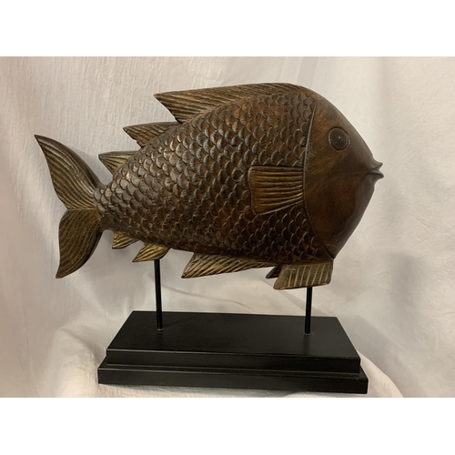 56 - A VERY LARGE HARD WOOD FISH MOUNTED ON A PLINTH OF THE SAME H: APPROX. 45CM