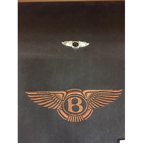 181 - TWO BENTLEY BADGES IN A MAHOGANY FRAME