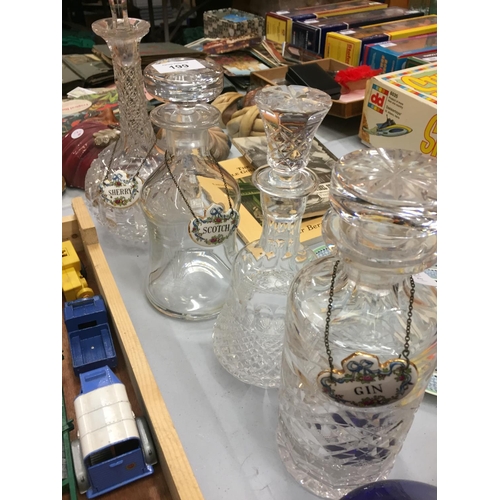 199 - FIVE GLASS DECANTERS WITH THREE BONE CHINA SPIRIT LABELS AND A SMALL CUT GLASS BOTTLE WITH STOPPER